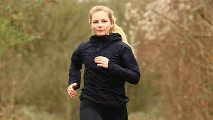 Rab Phantom Waterproof Jacket Woman running in Rab Phantom Waterproof Jacket