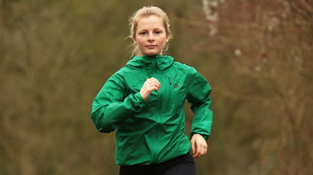 outdoor research helium rain jacket woman running in outdoor research helium rain jacket