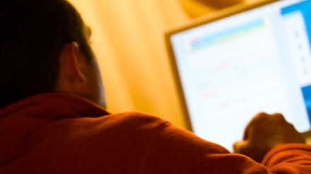 Image shows man using computer Image shows man using computer