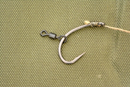 Trim the tag end of the knotless knot and then slide a small rig swivel on to the hook Trim the tag end of the knotless knot and then slide a small rig swivel on to the hook