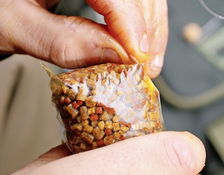 Once the top is sealed, push in the corners at the base of the bag Once the top is sealed, push in the corners at the base of the bag