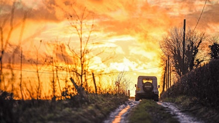 Land Rover heads towards a fiery sunset Land Rover heads towards a fiery sunset