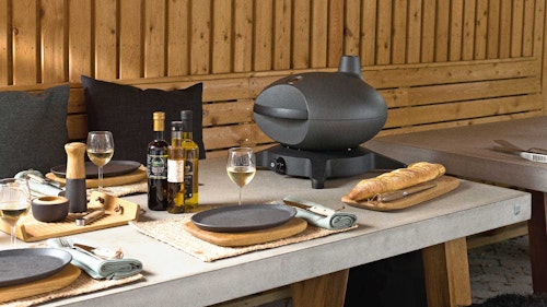 gas bbq near outdoor dining table