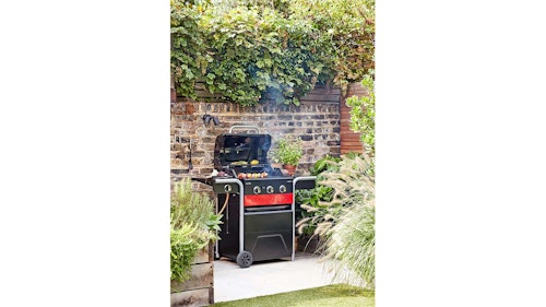 black and red gas bbq in sunny garden