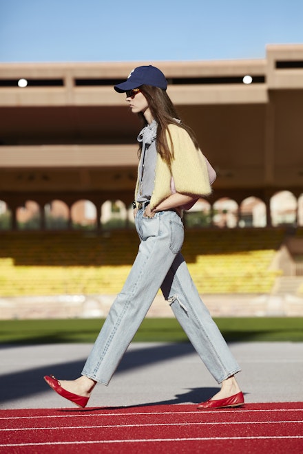 A model wearing jeans, a yellow cardigan and red ballet pumps at Celine SS21 A model wearing jeans, a yellow cardigan and red ballet pumps at Celine SS21