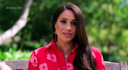 Meghan Markle wearing a red dress and a pendant necklace from Awe Meghan Markle wearing a red dress and a pendant necklace from Awe
