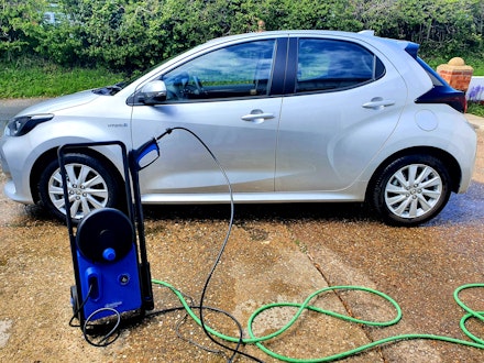 Nilfisk pressure washer hose and car outside Nilfisk pressure washer hose and car outside