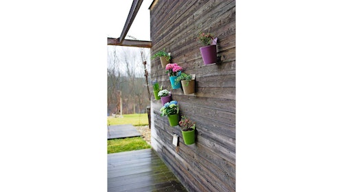 Pots hanging on wall in garden