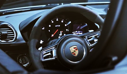 The alcantara steering wheel of a Porsche The alcantara steering wheel of a Porsche