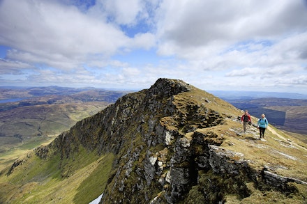 Expansive Highland views lie beyond the craggy northern face of Ben Lomond's summit ridge Expansive Highland views lie beyond the craggy northern face of Ben Lomond's summit ridge