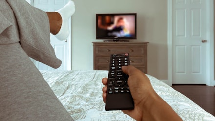 Woman watching TV from bed Woman watching TV from bed