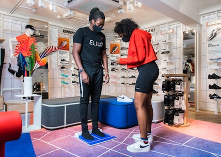 A customer trying on trainers at Nike by Kings Road A customer trying on trainers at Nike by Kings Road