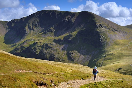 A walker on the lower slopes of Grisedale Pike, heading for Crag Hill. A walker on the lower slopes of Grisedale Pike, heading for Crag Hill.
