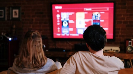 Couple of people watching TV Couple of people watching TV