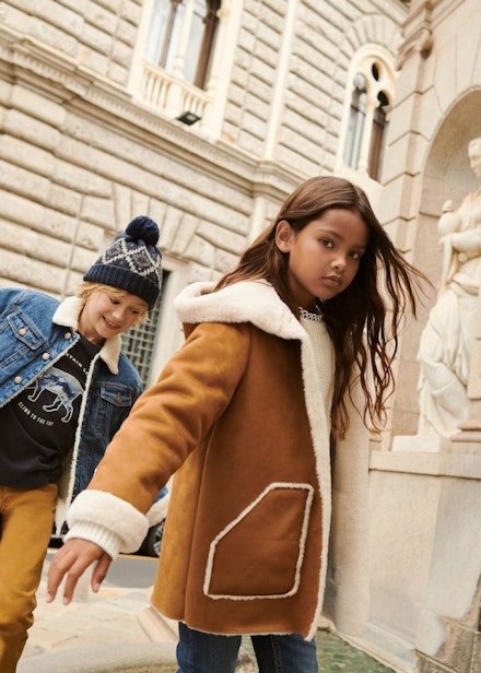 A little girl wearing a suedette coat from Mango A little girl wearing a suedette coat from Mango