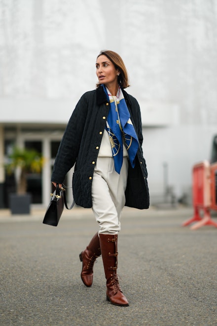 woman wearing knee high boots with trousers woman wearing knee high boots with trousers
