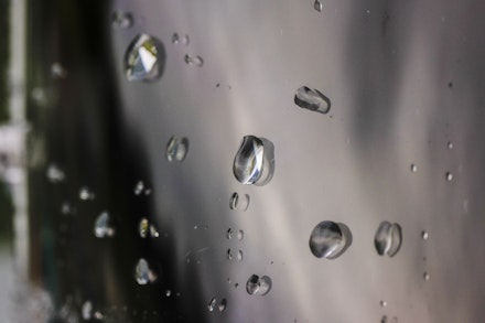 Water droplets bead together on a visor Water droplets bead together on a visor