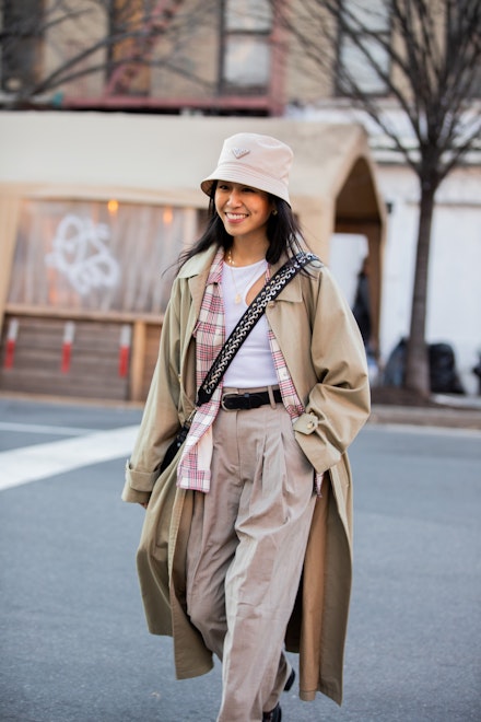 A woman wearing a trench coat at NYFW A woman wearing a trench coat at NYFW