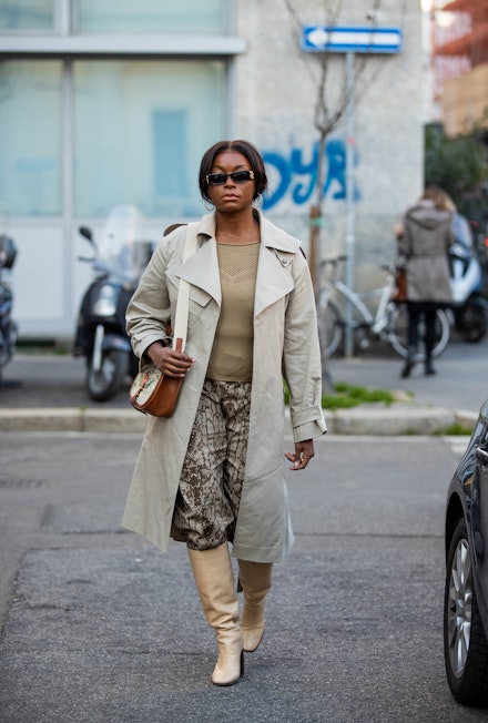 A woman wearing a trench coat at MFW A woman wearing a trench coat at MFW