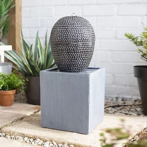 Grey cascade water feature on sunny patio