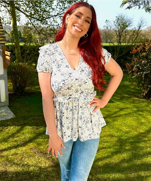 A picture of Stacey Solomon wearing the White and Blue Floral Peplum Top