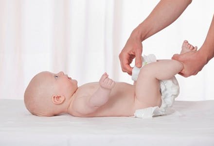 1) Why is my baby’s poo green? baby being changed