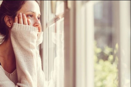woman-looking-through-window