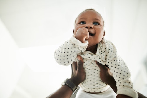 Cropped shot of an adorable baby girl being held by her father Week 7