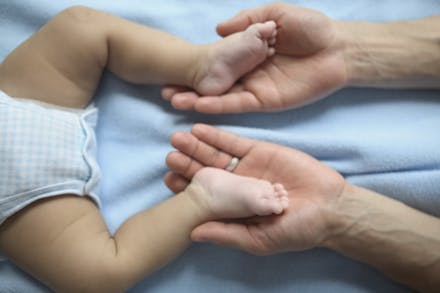 Hip dysplasia Mum holding babies feet