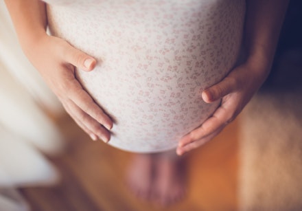 Pregnant woman touching her belly Growing Rapidly