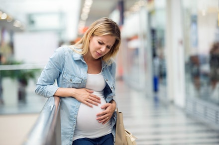 Pregnant woman touching her belly, having pains Water breaking