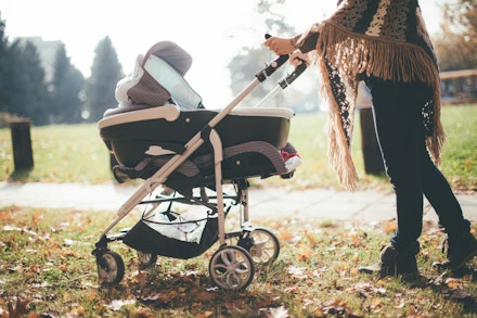 Young mother with a baby stroller Young mother with a baby stroller