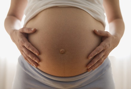 Close up of pregnant woman's belly third trimester