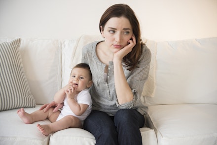 Mother with new baby suffering from postpartum depression mum with new baby looking sad