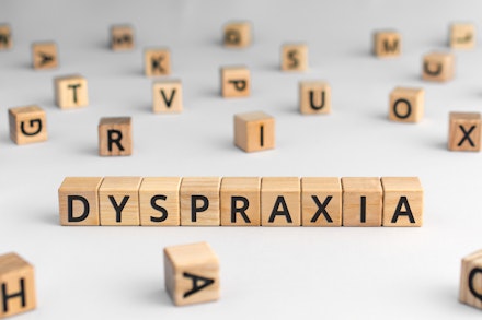 Dyspraxia - word from wooden blocks with letters Dyspraxia