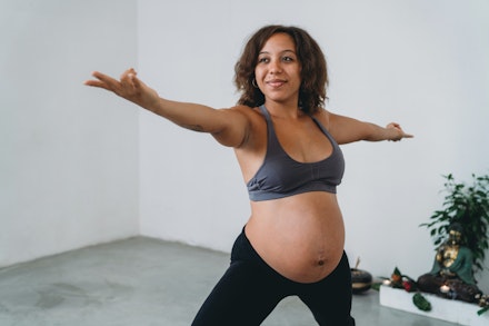 Young woman practicing yoga during her pregnancy pregnant woman doing yoga