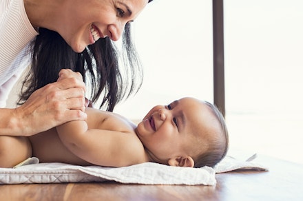 Mother changing diaper to toddler mum changing baby's nappy