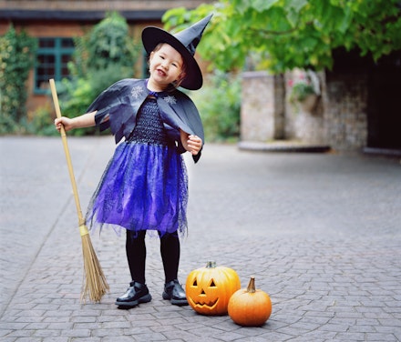 child with broomstick