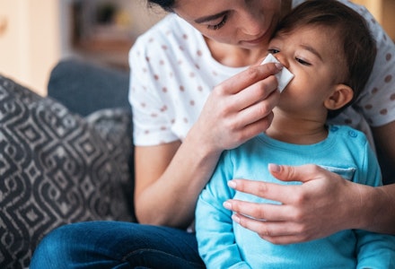 gettyimages mother helping her baby son to blow his nose