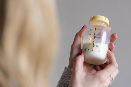 holding baby bottle