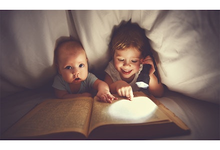 kids read story under covers