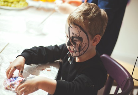 little boy is making slime on halloween party