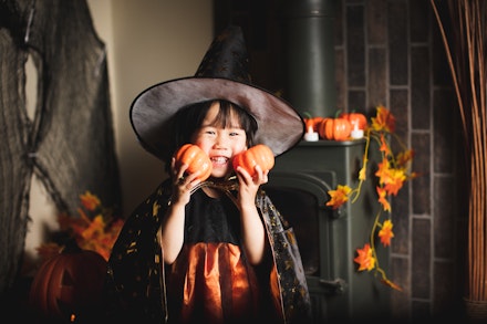 little girl with pumpkins