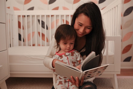 mum reading to toddler daughter