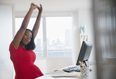 pregnant woman stretching at desk1