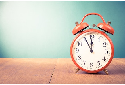 red alarm clock blue background