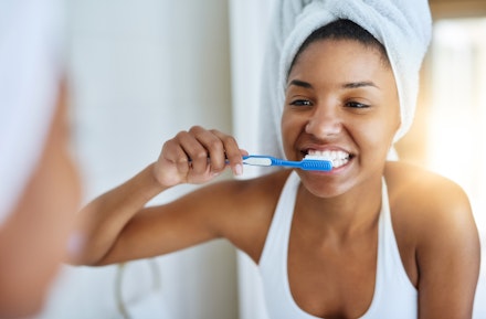 woman brushing teeth