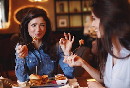 1) Go for dinner instead of drinks two women eating