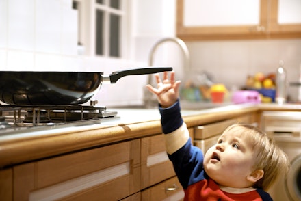 baby about to grab frying pan handle not safe