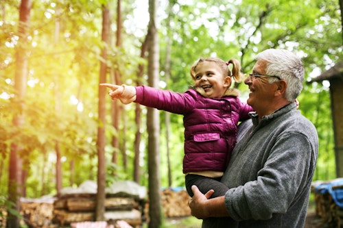 toddler and grandparent in wood